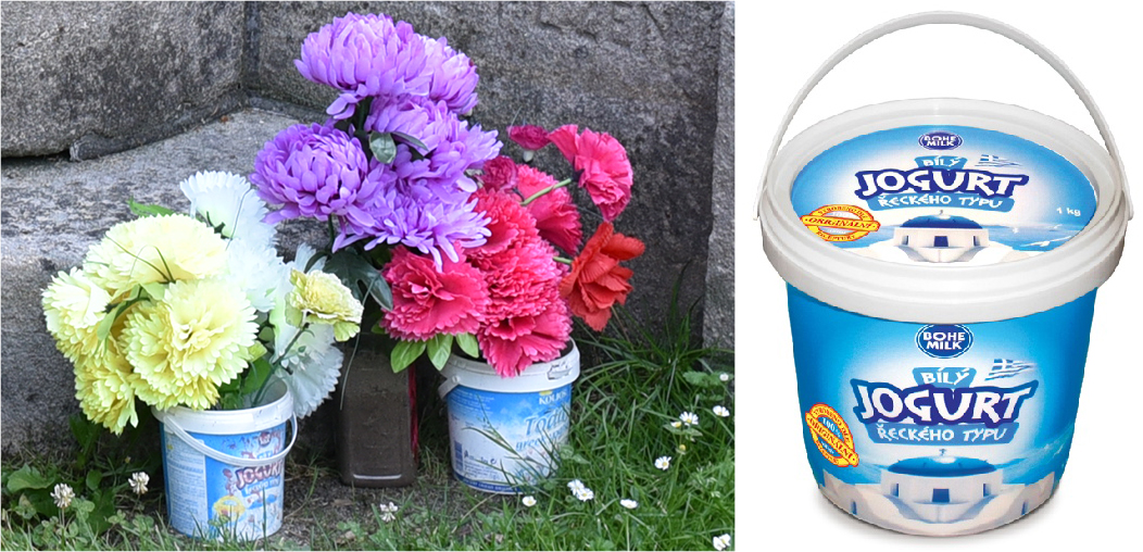 Květiny u pomníku Jana Husa v den oslav v kyblíkách od jogurtu řeckého typu